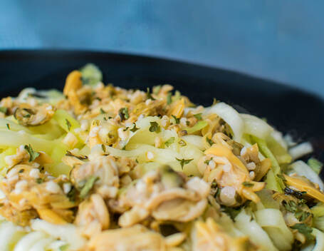 Spiralized zucchini noodles covered with white clam sauce